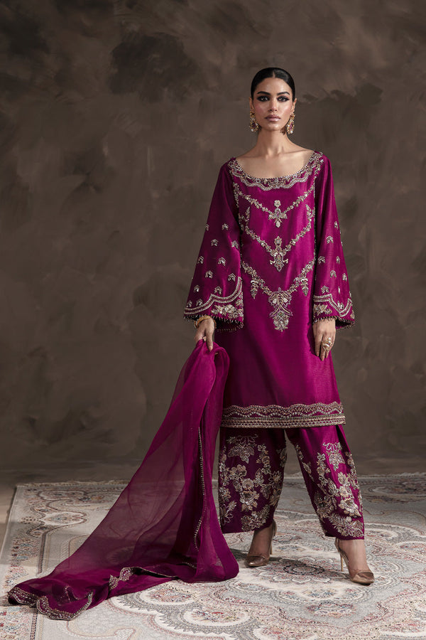 A classic burgundy shalwar kameez featuring wide opensleeves adds a touch of regal charm, while intricate floral trellises adorn the kameez front and back, shimmering with handcrafted gold, copper, and silver tone embellishments. Each stitch, delicately woven with cora, tilla, and dabka, tells a story of exquisite craftsmanship. To complete the look dyed organza dupatta comes along. Product Details Shirt: Pure Raw silk Trouser: Raw silk Dupatta: Pure Organza