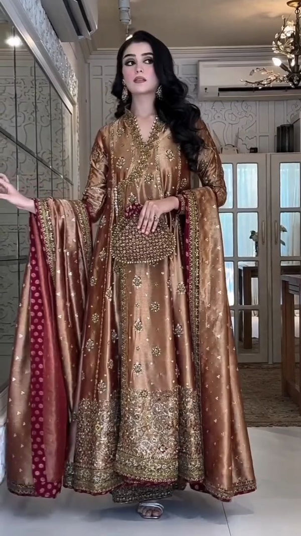Haris Shakeel - Copper Gold Hibiscus Angrakha pakistani indian wedding bridal dress, mehndi nikkah oufits guest suits
Product Description: Haris Shakeel embodies a white color on an net, which features intricate embroidery inspired by nature’s floral composition all over. Further layered with mesmerizing embellishments of sequins, pearls, and crystals. The outfit is paired with a modern look flared pants, and a sophisticatedly embroidered dupatta concluded with minimalistic borders, making this ensemble jus